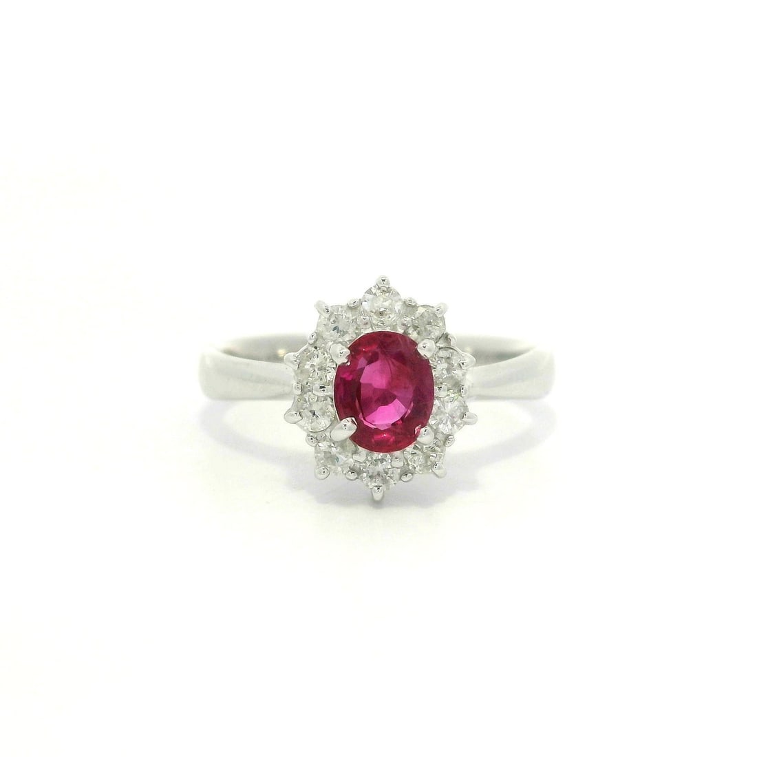 Platinum Cocktail Ring with Oval Ruby and Diamond Halo Cluster: Platinum Cocktail Ring with Oval Ruby and Diamond Halo Cluster This exquisite cocktail ring features a stunning oval-cut natural ruby at its center, surrounded by a halo of ten brilliant round diamond