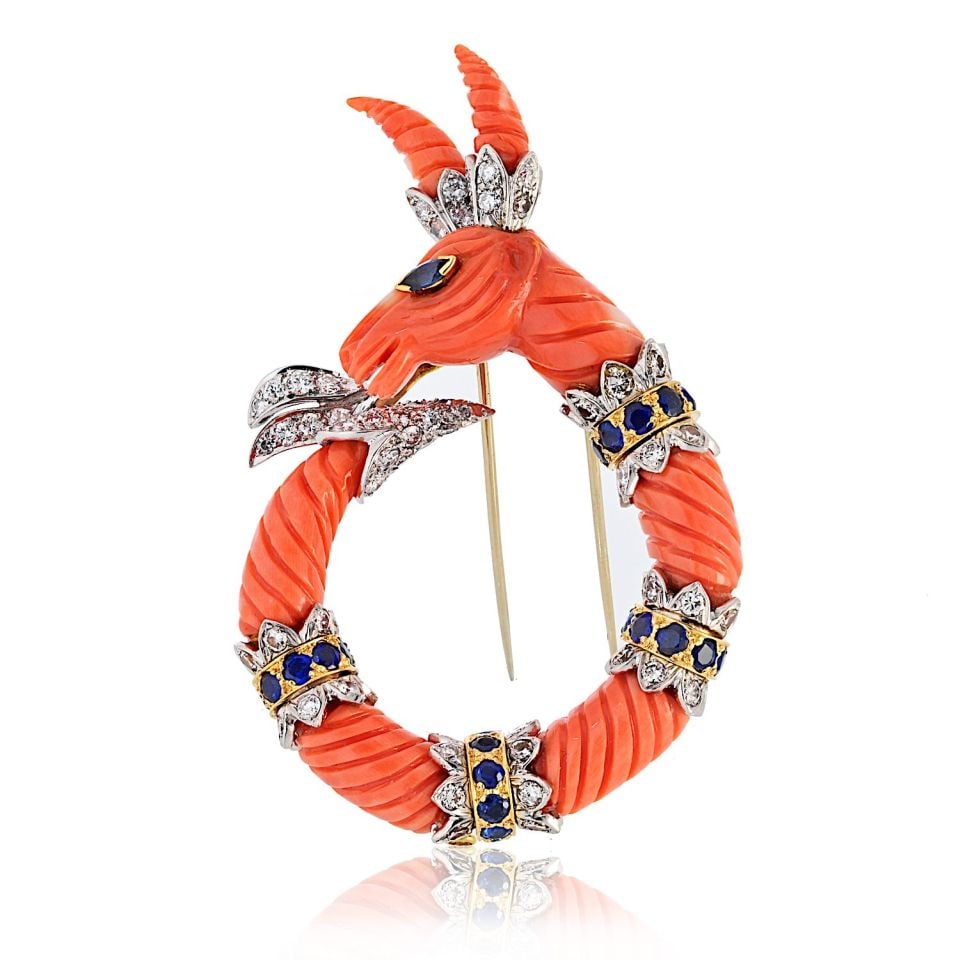 David Webb Platinum 18K Yellow Gold Coral Capricorn Brooch: David Webb Platinum 18K Yellow Gold Coral Capricorn Brooch This exquisite vintage brooch by David Webb features a beautifully carved coral mountain goat, representing the Capricorn zodiac sign. Crafte