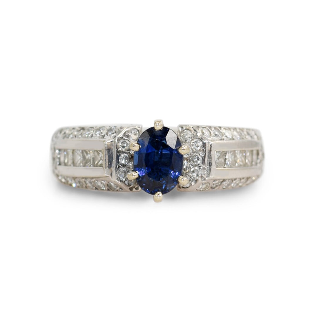 Blue Sapphire Diamond 14K White Gold Ring Size 7: Blue Sapphire Diamond 14K White Gold Ring Size 7 This elegant ladies' ring features a 1.00 carat dark blue oval sapphire set in a 14K white gold setting. Accented with round brilliant and princess cut
