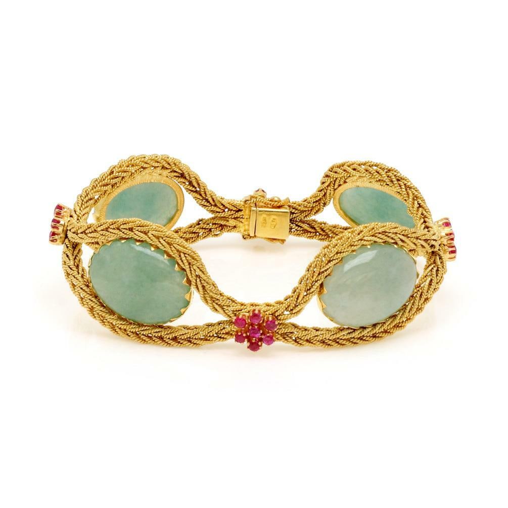 18k Yellow Gold Jade and Ruby Floral Link Bracelet 7.5 in: 18k Yellow Gold Jade and Ruby Floral Link Bracelet 7.5 in Elegant floral bracelet crafted in 18k yellow gold with a soft flex link design. The bracelet features four open loops formed from woven chain