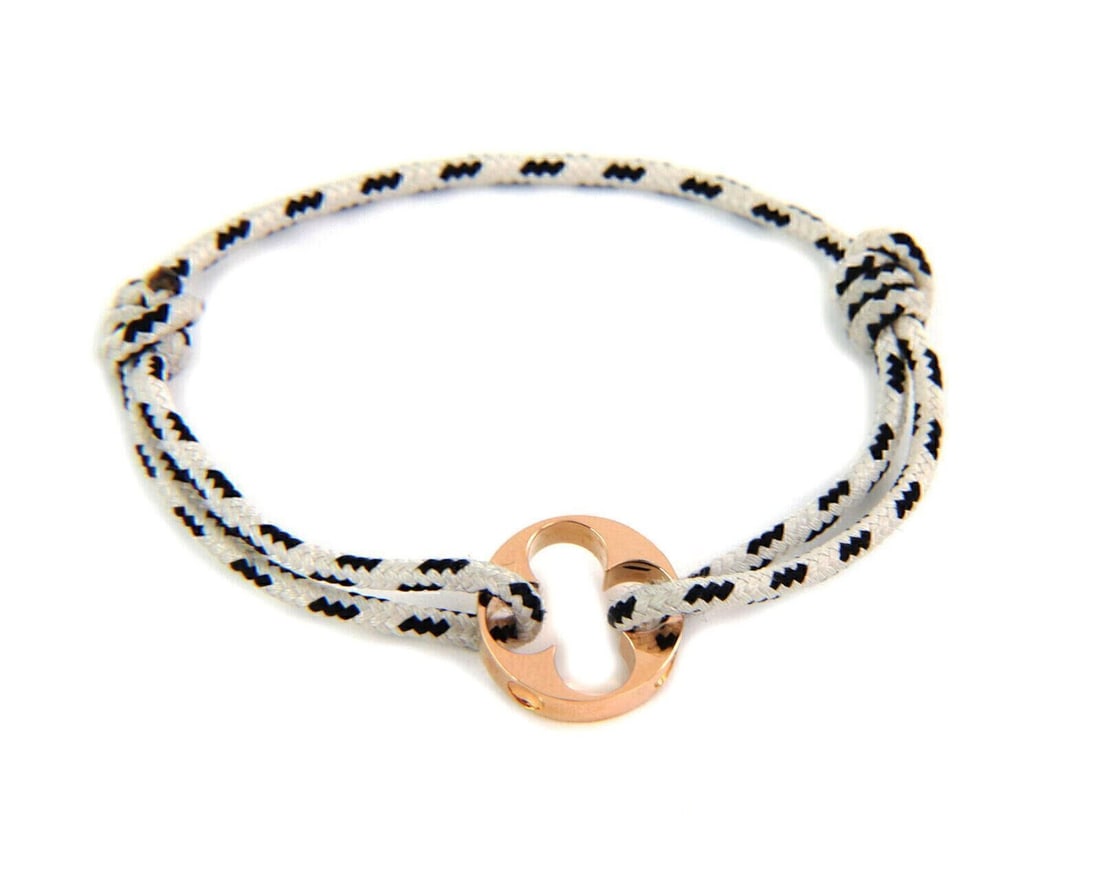 Louis Vuitton Empreinte Cord Charm Bracelet in 18k Rose Gold: Louis Vuitton Empreinte Cord Charm Bracelet in 18k Rose Gold Louis Vuitton Empreinte cord charm bracelet crafted in 18k rose gold with a signature engraved round charm on an adjustable black and white