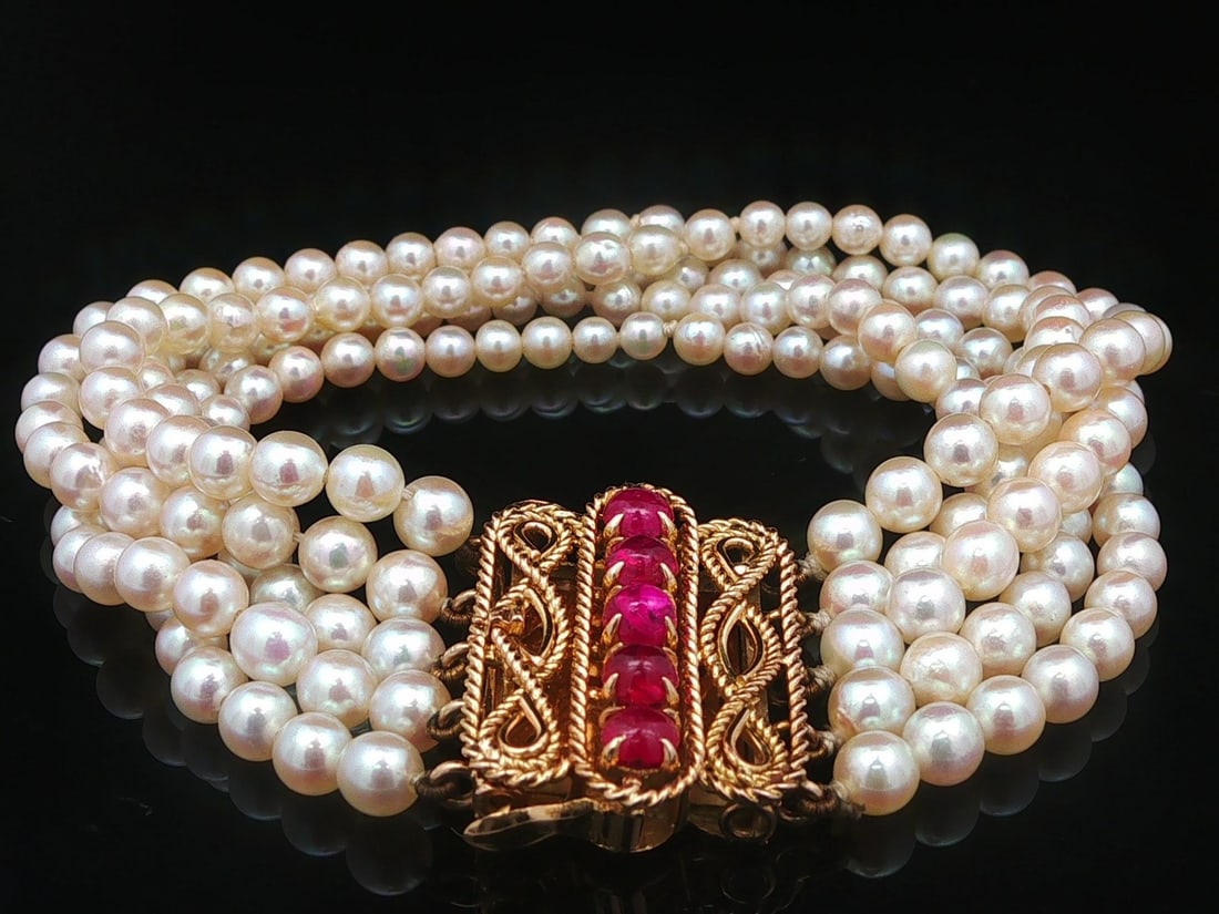 GIA certified 5 strand pearl bracelet 18k gold Burma ruby clasp: GIA certified 5 strand pearl bracelet 18k gold Burma ruby clasp This vintage French bracelet features five strands of genuine saltwater Akoya cultured pearls, each near-round in shape with a light cre