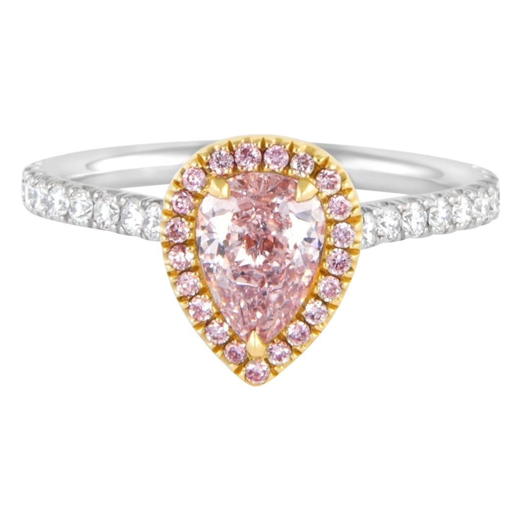 0.76ct GIA Fancy Light Pink Diamond Halo Ring: 0.76ct GIA Fancy Light Pink Diamond Halo Ring This stunning ring features a GIA-certified 0.76ct Fancy Light Pink diamond at its center, elegantly set in a halo of 22 round brilliant diamonds totaling