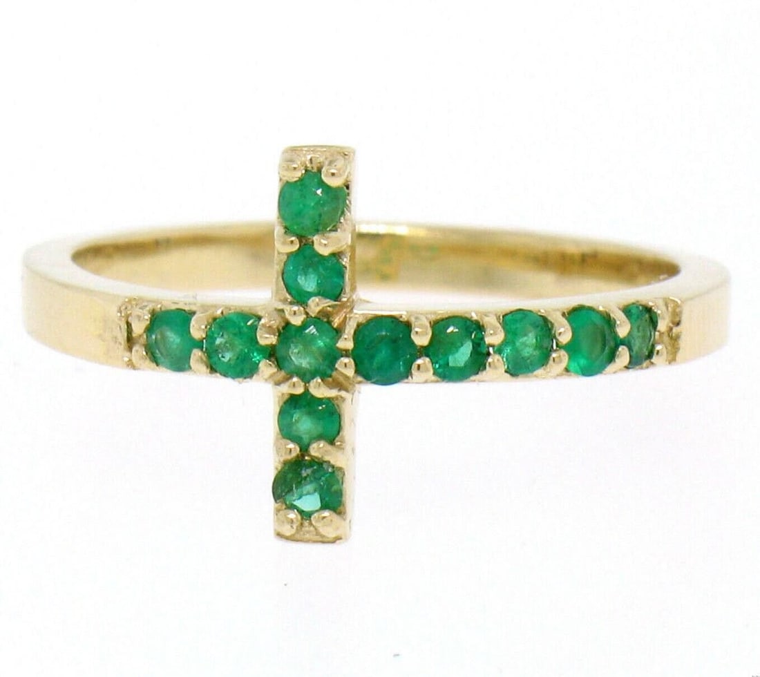 14k Yellow Gold Emerald Cross Band Ring 0.25ctw Size 6: 14k Yellow Gold Emerald Cross Band Ring 0.25ctw Size 6 Un-used 14k yellow gold band ring featuring a curved sideways cross design set with natural green emeralds. The ring is styled with round brillia