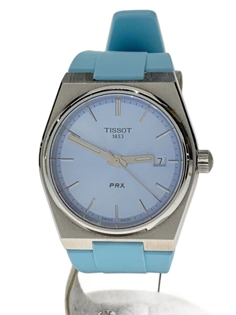 Tissot PRX Blue Rubber Band Women's Quartz Wristwatch: Tissot PRX Blue Rubber Band Women's Quartz Wristwatch This TISSOT PRX Quartz T137210A women's wristwatch features a blue dial and a rubber strap. Crafted in Switzerland, it showcases a slightly used c