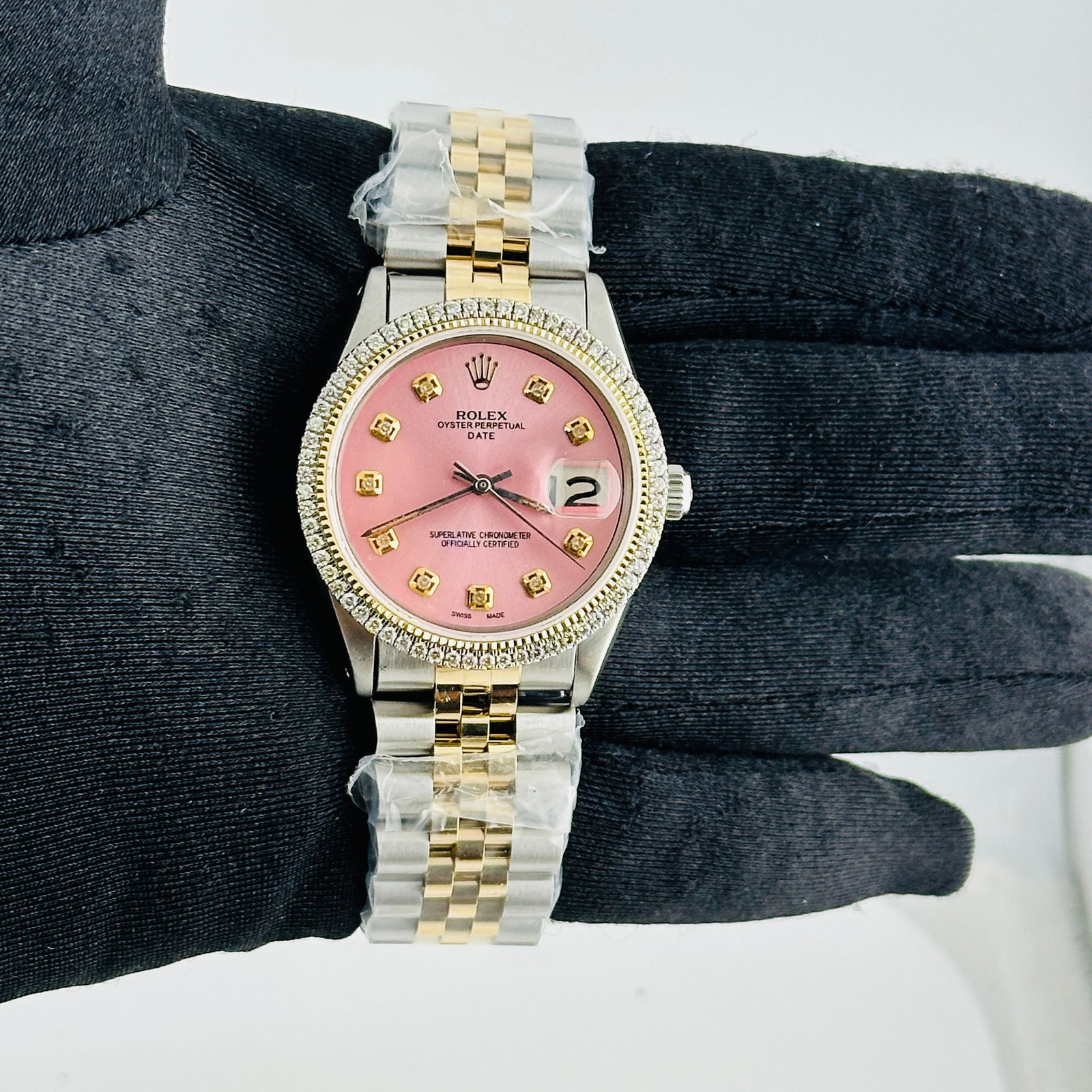 Pink Diamond Dial Rolex Ref 6694 Aftermarket Jubilee Bracelet Watch: Pink Diamond Dial Rolex Ref 6694 Aftermarket Jubilee Bracelet Watch This Rolex Date watch features an aftermarket pink diamond dial and is designed with a prong plated bezel. It includes an aftermarke