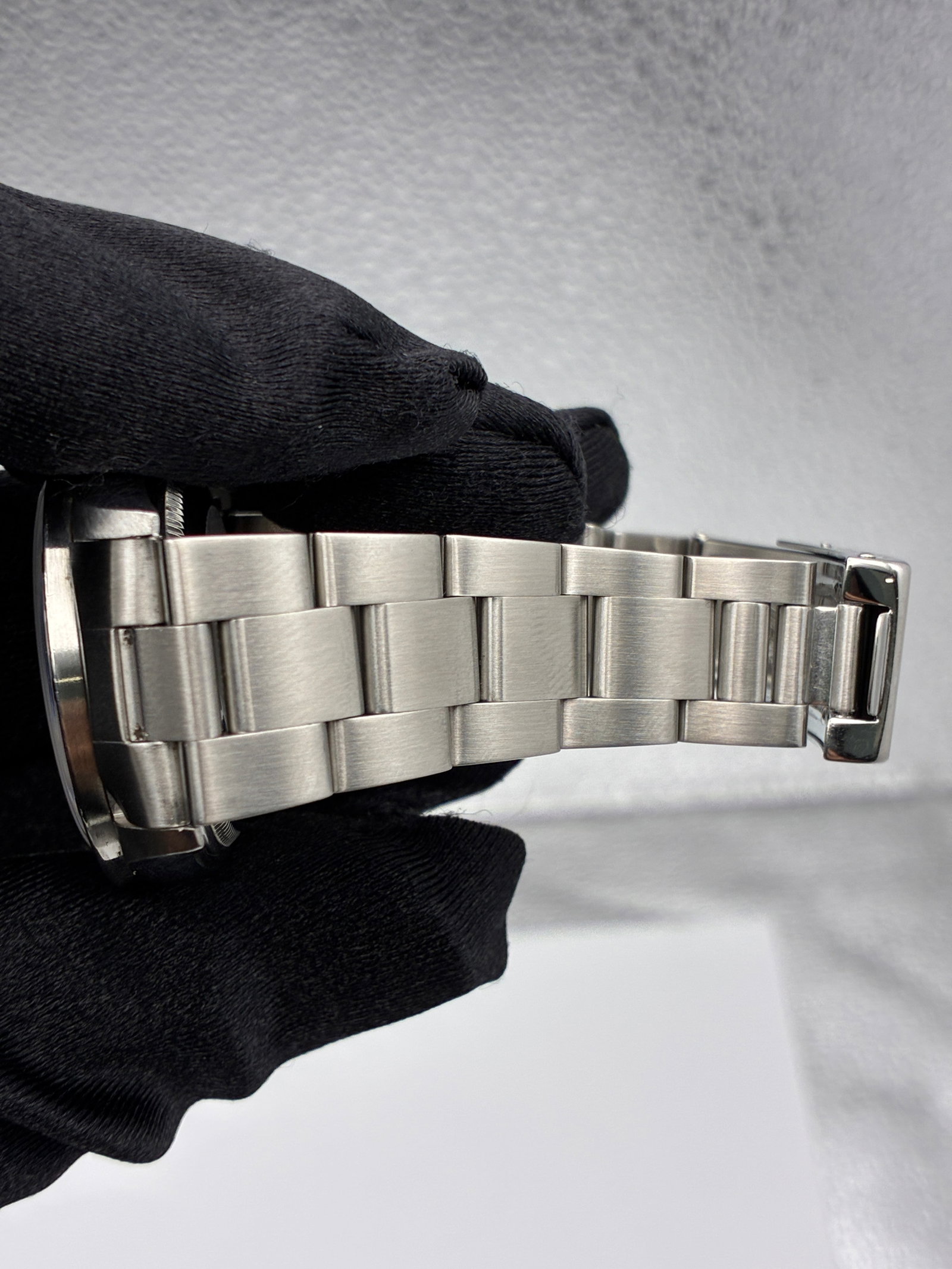 Rolex Oyster Perpetual 14010 White Roman Dial Oyster Bracelet: Rolex Oyster Perpetual 14010 White Roman Dial Oyster Bracelet This Rolex Oyster Perpetual features a white factory Roman numeral dial and an engine-turned bezel. The watch is equipped with a classic O