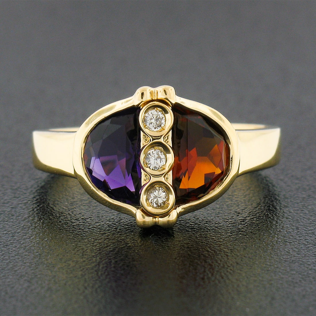 18k Yellow Gold Half Moon Amethyst Garnet Diamond Ring: 18k Yellow Gold Half Moon Amethyst Garnet Diamond Ring This ring features a striking combination of half moon-cut spessartite garnet and amethyst, both bezel set in solid 18k yellow gold. The spessart