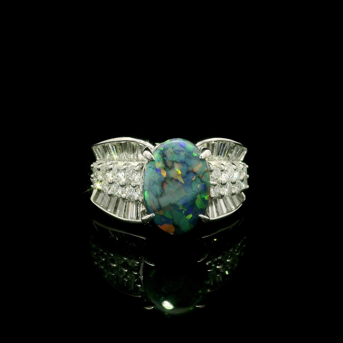 GIA Certified 2.72ctw Black Opal Platinum Cocktail Ring with Diamonds: GIA Certified 2.72ctw Black Opal Platinum Cocktail Ring with Diamonds This stunning cocktail ring showcases a mesmerizing natural black opal at its center, elegantly framed by sparkling diamonds. The 