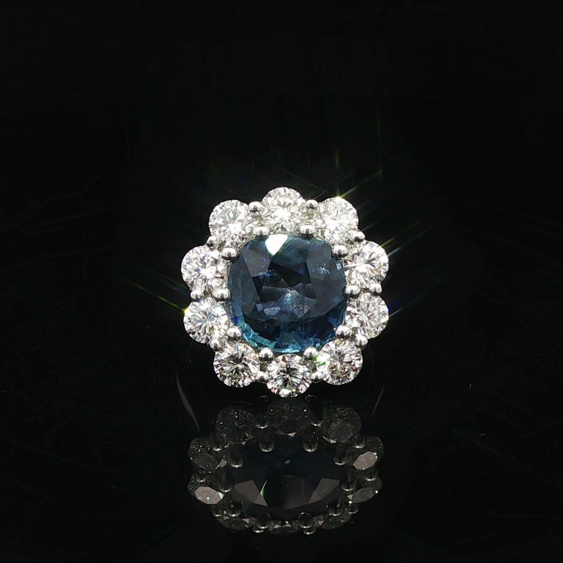 Platinum Burma Sapphire and Diamond Halo Ring GIA Certified No Heat 6.69ct: Platinum Burma Sapphire and Diamond Halo Ring GIA Certified No Heat 6.69ct This platinum cocktail ring features a large, cushion-cut natural blue sapphire from Burma, weighing 4.50 carats and certifie