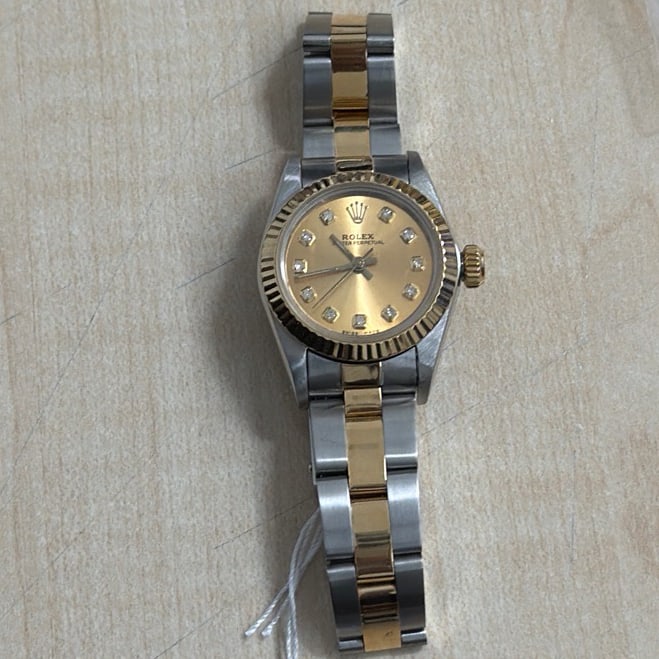Rolex Oyster Perpetual Ladies Watch Ref 67193 Fluted Bezel Oyster Bracelet: Rolex Oyster Perpetual Ladies Watch Ref 67193 Fluted Bezel Oyster Bracelet This ladies Rolex Oyster Perpetual watch features a champagne stick dial, a fluted bezel, and an Oyster bracelet. The referen