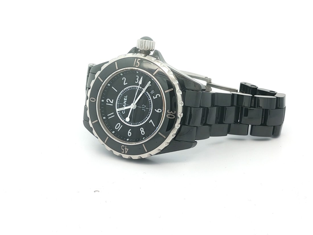 Chanel J12 Black Ceramic 33mm Ladies Swiss Quartz Watch: Chanel J12 Black Ceramic 33mm Ladies Swiss Quartz Watch This ladies Chanel J12 wristwatch features a 33mm black ceramic and stainless steel case with a matching black ceramic bracelet. The unidirectio