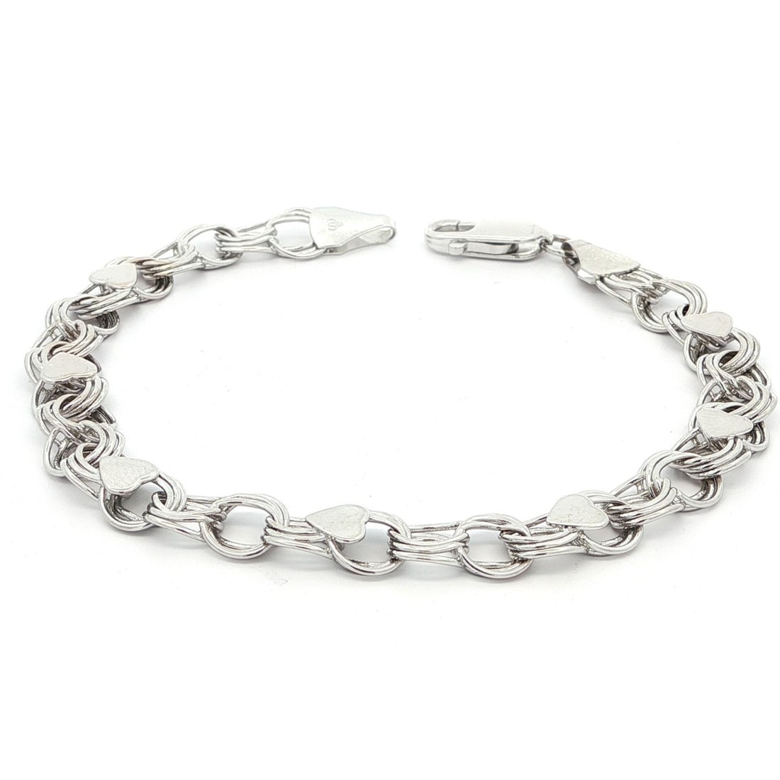 14k White Gold Interlocking Heart Charm Bracelet 7.75in: 14k White Gold Interlocking Heart Charm Bracelet 7.75in This exquisite bracelet features interlocking circular links and charming heart stations, crafted from solid 14k white gold. Designed as a