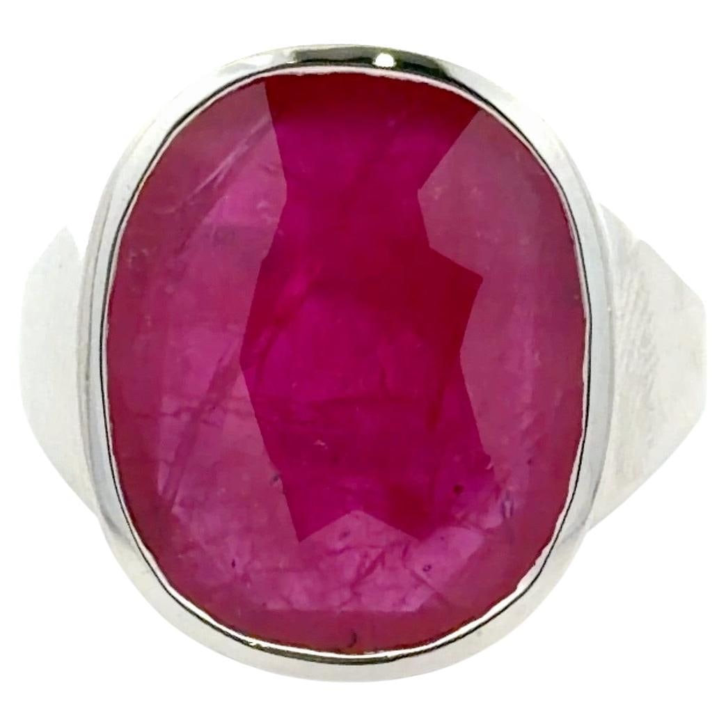 Oval 9.56ct Ruby Statement Ring with Hidden Diamond Halo in 14K White Gold: Oval 9.56ct Ruby Statement Ring with Hidden Diamond Halo in 14K White Gold This sophisticated 14K white gold ring showcases a vivid 9.56 carat oval-cut natural ruby at its center. The ruby is