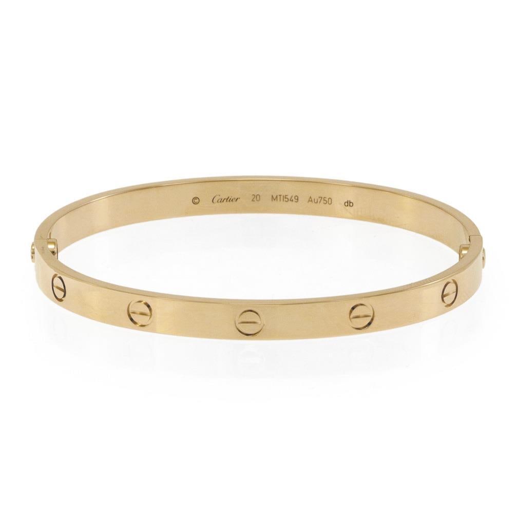 Cartier Love 18k Yellow Gold Bangle Size 20 With Certificate Box Screwdriver: Cartier Love 18k Yellow Gold Bangle Size 20 With Certificate Box Screwdriver This authentic Cartier Love bangle from the iconic LOVE Collection is crafted in 18k yellow gold with a high-polished finis