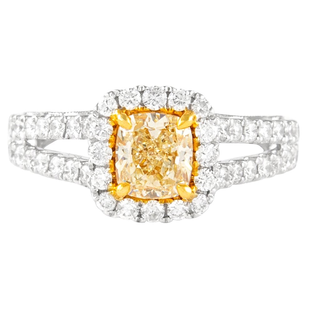 18k Two Tone Halo Ring with 1.74ctt Fancy Yellow Diamond: 18k Two Tone Halo Ring with 1.74ctt Fancy Yellow Diamond Contemporary halo ring featuring a Fancy Yellow cushion cut diamond surrounded by round brilliant diamonds in a two-tone 18k yellow and white g