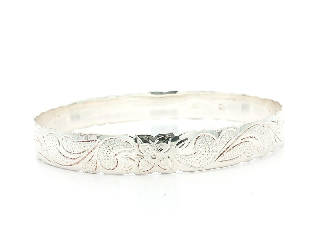 Sterling Silver Slip On Bangle Bracelet with Hawaiian Plumeria Design: Sterling Silver Slip On Bangle Bracelet with Hawaiian Plumeria Design Handmade slip-on bangle bracelet featuring a Hawaiian plumeria flower design in solid sterling silver. This women's bracelet has a
