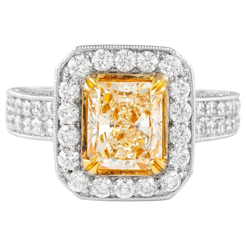 18k Gold Ring 2.08ct Fancy Yellow Radiant VVS2 Diamond: 18k Gold Ring 2.08ct Fancy Yellow Radiant VVS2 Diamond Contemporary ring featuring a 2.08 ct Fancy Yellow VVS2 radiant cut diamond in a halo setting with additional round brilliant diamonds. Crafted i