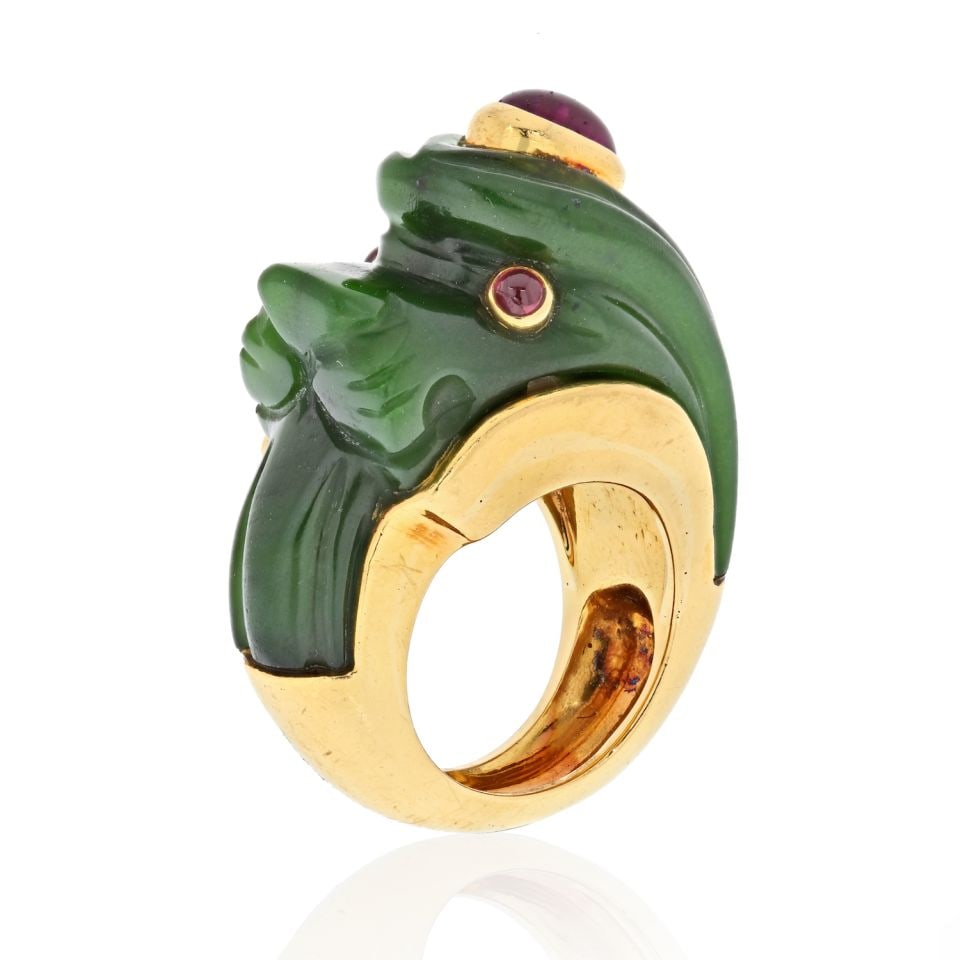 David Webb Lion Ring 18K Yellow Gold Nephrite Ruby Eyes: David Webb Lion Ring 18K Yellow Gold Nephrite Ruby Eyes Estate ring by David Webb, modeled as a lion with a carved nephrite body and cabochon ruby eyes, mounted in 18K yellow gold. Signed WEBB. Pre-ow