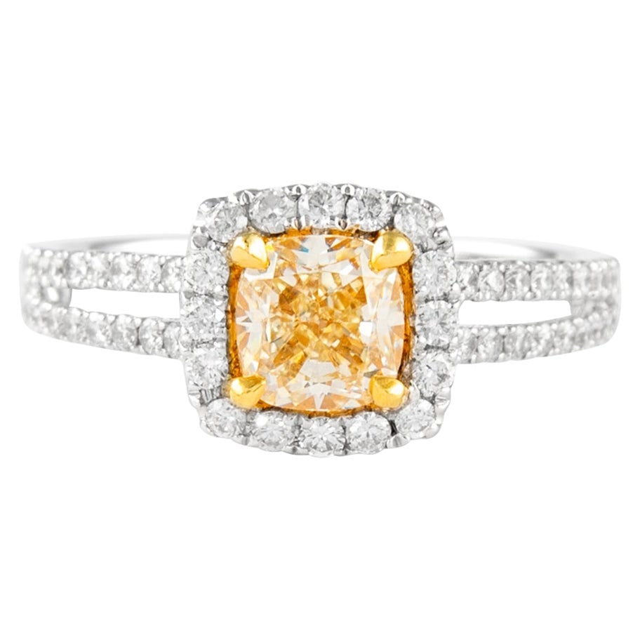 18k Gold Halo Ring with 1.59ctt Fancy Yellow Cushion Diamond: 18k Gold Halo Ring with 1.59ctt Fancy Yellow Cushion Diamond Contemporary halo ring featuring a cushion-cut Fancy Yellow diamond surrounded by round brilliant diamonds. Crafted in two-tone 18k yellow 