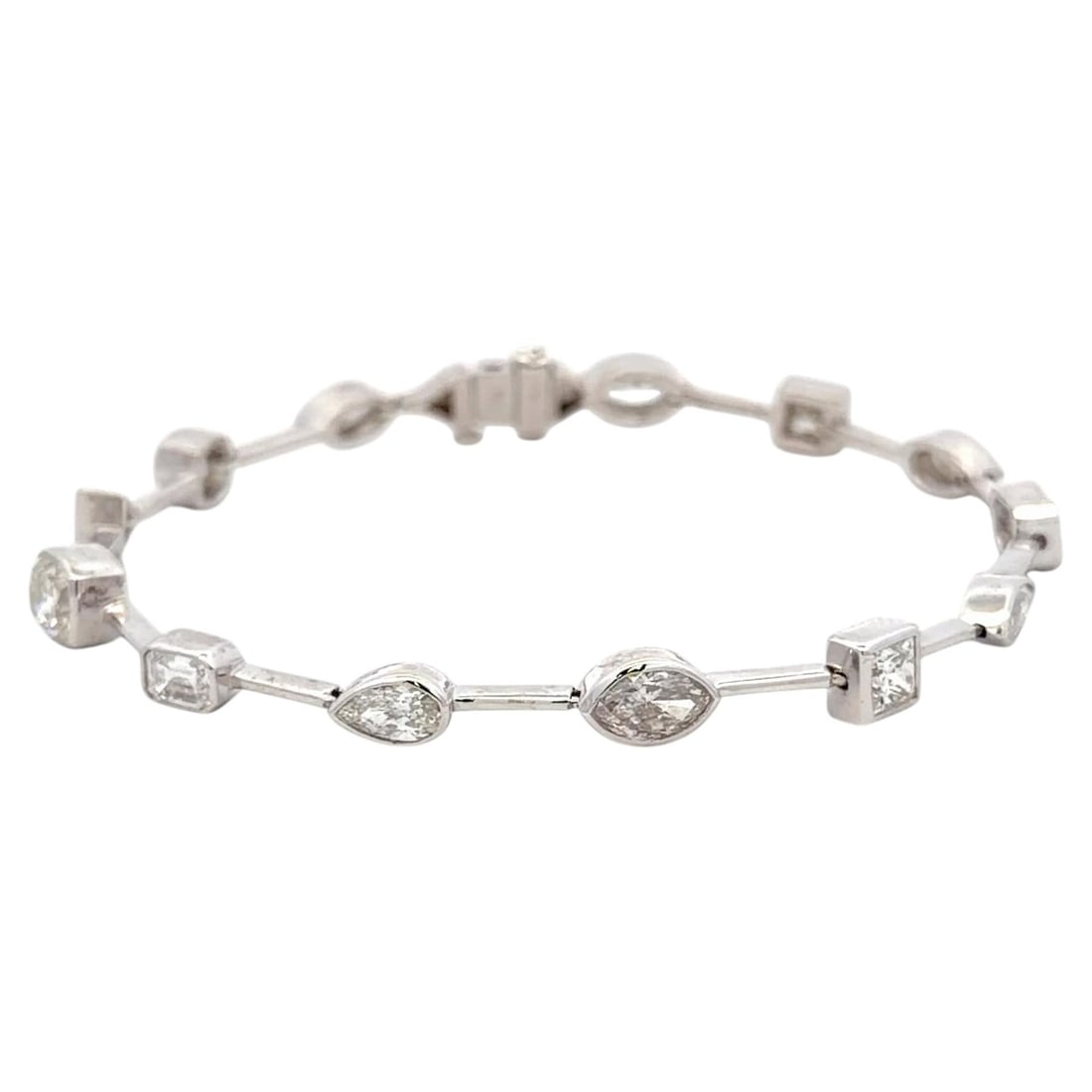 18K White Gold Diamond Tennis Bracelet 6.62 Carats Multi Shape Bezel Set: 18K White Gold Diamond Tennis Bracelet 6.62 Carats Multi Shape Bezel Set A contemporary multi-shape tennis bracelet featuring 13 bezel-set diamonds arranged in a refined geometric design. Crafted in 1