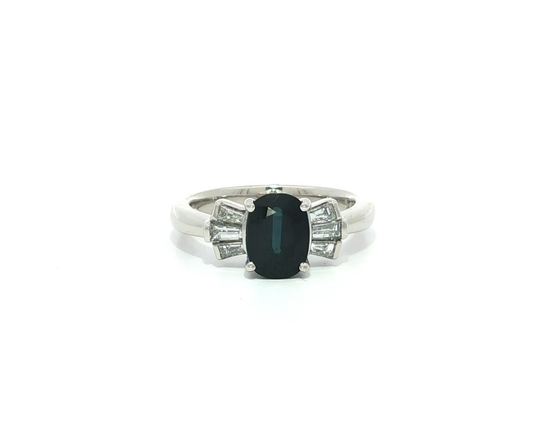 2ctw Oval Blue Sapphire Diamond Bow Ring in Platinum: 2ctw Oval Blue Sapphire Diamond Bow Ring in Platinum This exquisite cocktail ring features a stunning solid platinum design adorned with a vibrant natural oval sapphire and brilliant diamonds. The cen
