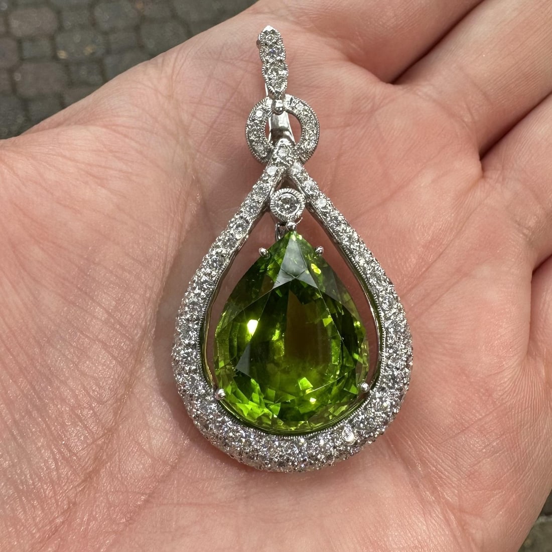 GIA Certified Burma Peridot Diamond Enhancer Pendant in White Gold 34.79ctw: GIA Certified Burma Peridot Diamond Enhancer Pendant in White Gold 34.79ctw Vintage enhancer pendant featuring a natural pear-cut Burma peridot accented by numerous round brilliant-cut pave-set diamon