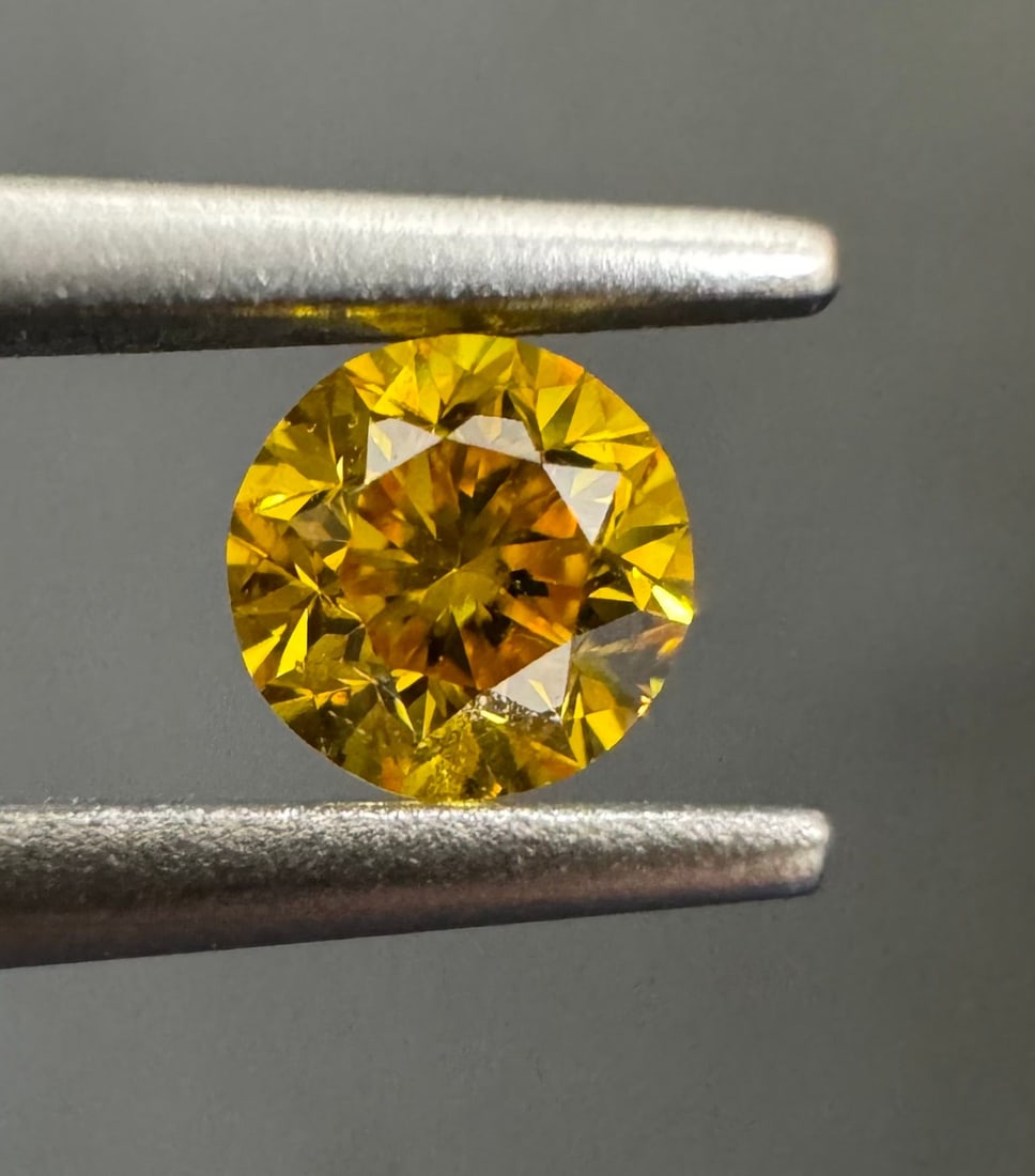 Loose Diamond - ROUND 0.2ct Fancy Vivid Orangey Yellow SI2: Loose Diamond - ROUND 0.2ct Fancy Vivid Orangey Yellow SI2 Source: Natural Shape: ROUND Carats: 0.2 Color: Fancy Vivid Orangey Yellow Certification: GIA The Diamond Depot Guarantee: All items in this 