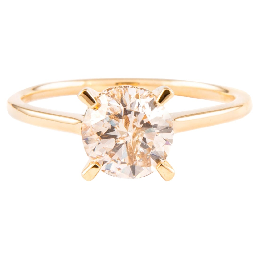 1.21 Carat Round Diamond Solitaire Ring in 18K Yellow Gold: 1.21 Carat Round Diamond Solitaire Ring in 18K Yellow Gold This stunning ring features a classic solitaire design, showcasing a 1.21 carat round brilliant diamond at its center, complemented by a hidd