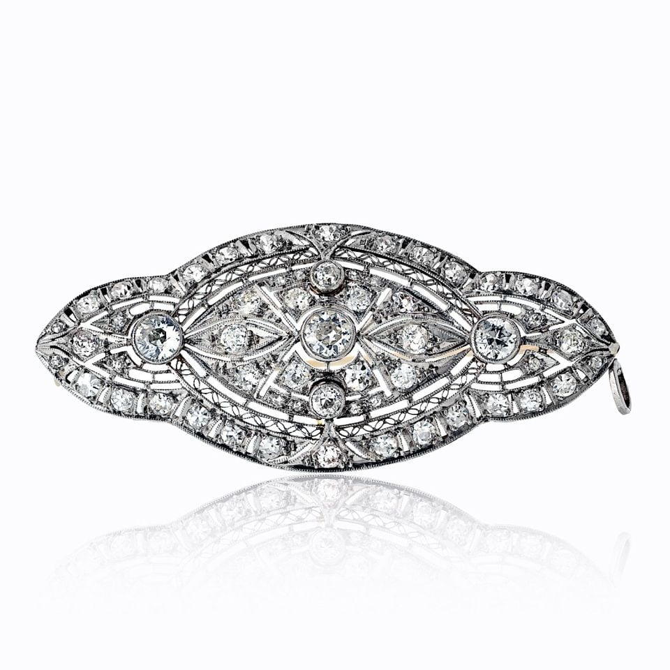 Antique Diamond Brooch in Platinum Openwork 3.00 cttw: Antique Diamond Brooch in Platinum Openwork 3.00 cttw Antique platinum diamond brooch featuring an openwork design set with round cut diamonds. This pre-owned pin has a refined antique style and a sin