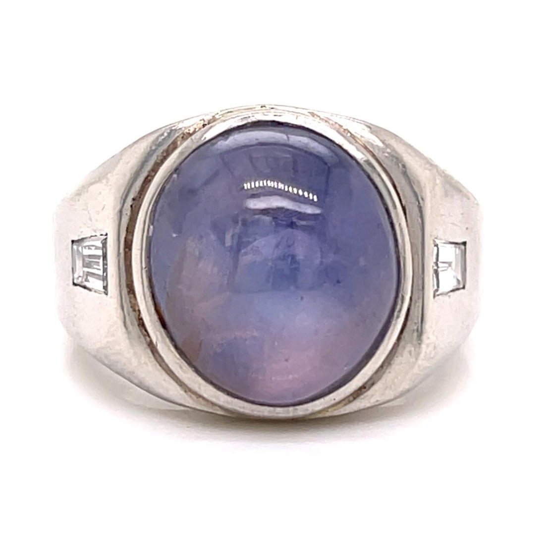 Platinum Art Deco Ring Featuring Star Sapphire and Diamond Accents: Platinum Art Deco Ring Featuring Star Sapphire and Diamond Accents This Art Deco platinum ring features an approximately 18.00 carat star sapphire, complemented by two baguette diamonds with a total w