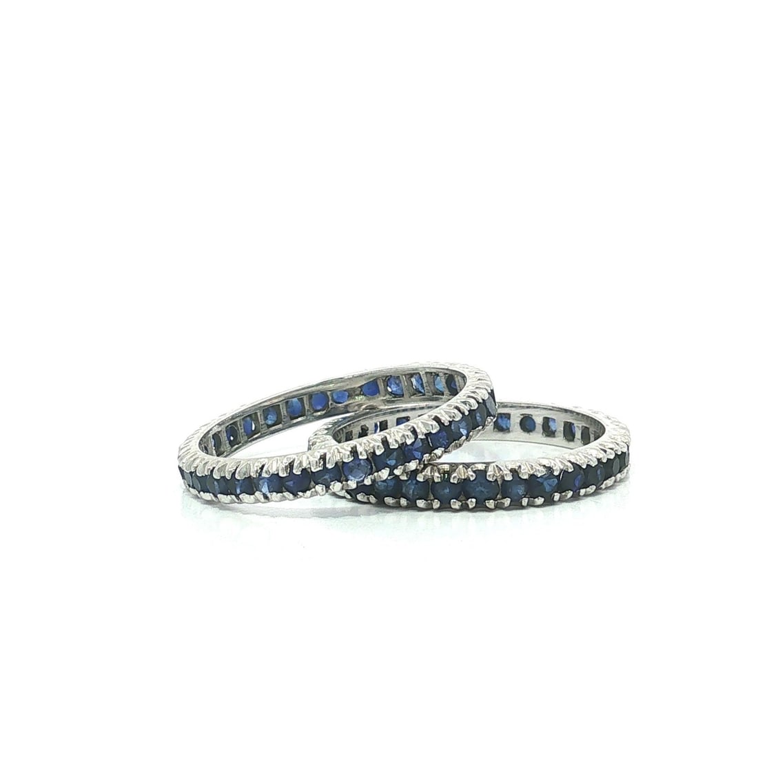 Pair of 13-14k White Gold Eternity Band Guard Rings Blue Stones Size 6.5: Pair of 13-14k White Gold Eternity Band Guard Rings Blue Stones Size 6.5 Vintage pair of women's eternity stack band guard rings in solid white gold, set with numerous round blue stones in a prong set