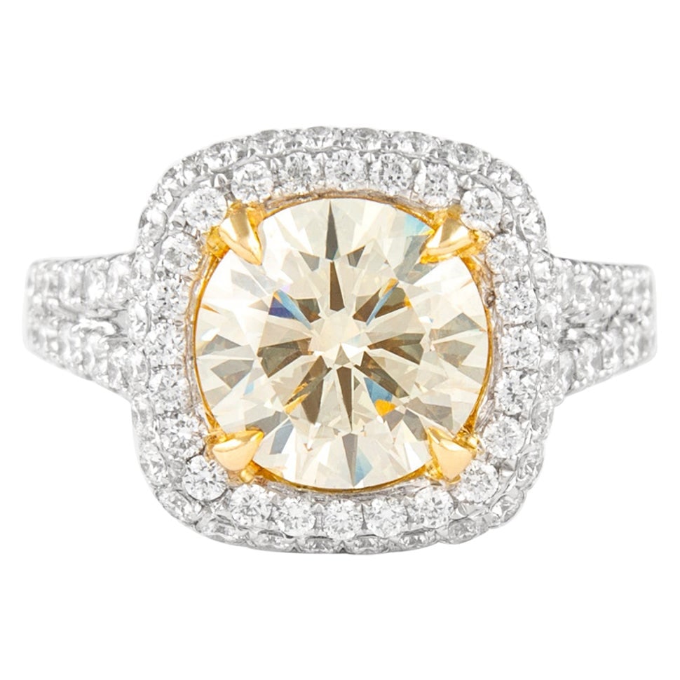 halo diamond ring 3.77ctt light yellow 18k gold: halo diamond ring 3.77ctt light yellow 18k gold Contemporary halo ring featuring a light yellow round diamond center accented by white diamonds in a split shank setting. Crafted in two-tone 18k white 