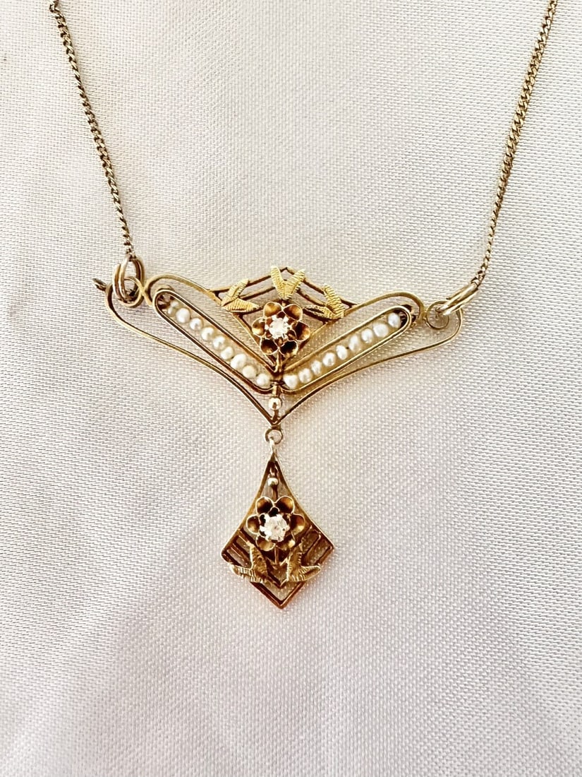 Early 1900s 14K Yellow Gold Pearl Diamond Pendant Necklace: Early 1900s 14K Yellow Gold Pearl Diamond Pendant Necklace An early 1900s necklace crafted in 14k yellow gold with diamond and pearl accents. Designed with a pendant-style center, this pre-owned piece