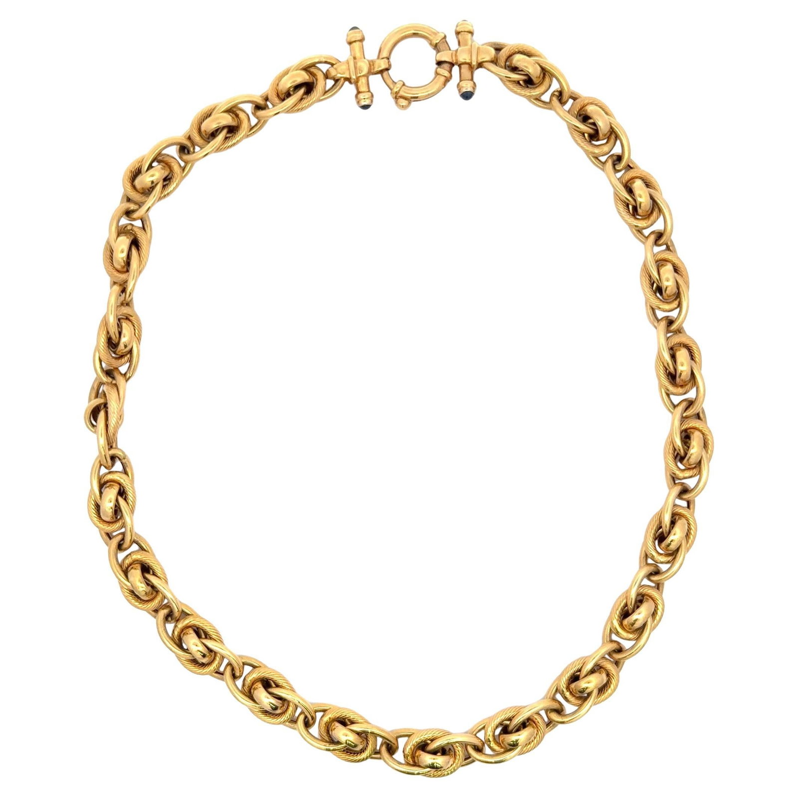 Italian 14k Yellow Gold Necklace with 4 Interlocking Links and Sapphires: Italian 14k Yellow Gold Necklace with 4 Interlocking Links and Sapphires Italian-made contemporary necklace in 14 karat yellow gold, designed with four interlocking links, a toggle clasp, and four cab