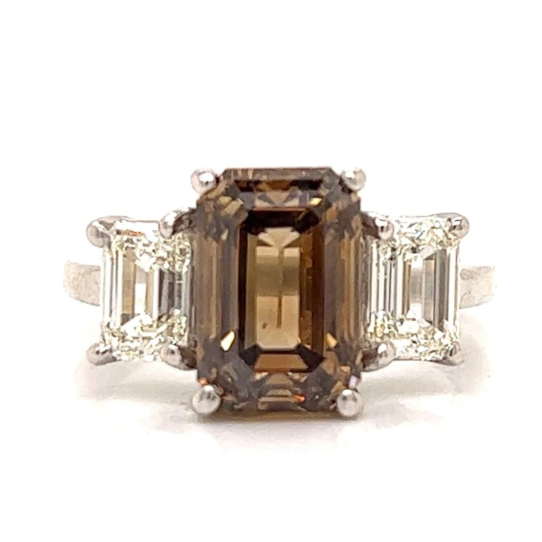 GIA Certified 4.01 Ct. Fancy Dark Yellowish Brown Diamond Platinum Ring: GIA Certified 4.01 Ct. Fancy Dark Yellowish Brown Diamond Platinum Ring This exquisite platinum ring features a stunning 4.01 Ct. GIA Certified Natural Fancy Dark Yellowish Brown Emerald-cut Diamond, 