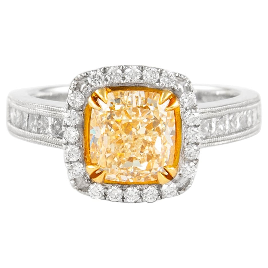 18k Yellow and White Gold 2.03ct Fancy Intense Yellow Diamond Ring: 18k Yellow and White Gold 2.03ct Fancy Intense Yellow Diamond Ring Fancy Intense Yellow cushion diamond ring in 18k white and yellow gold with a halo setting and twisted shank. Centered by a 2.03 ct E