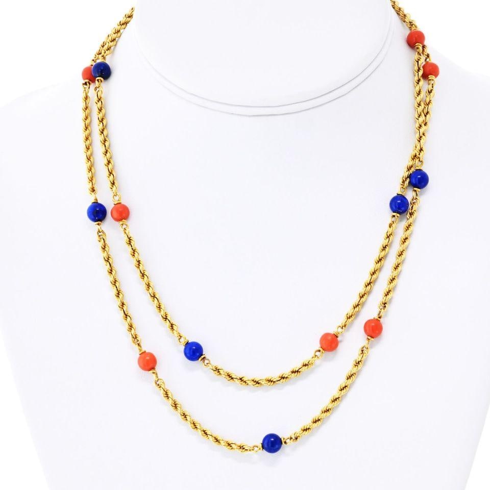 33 Inch Lapis Lazuli and Coral Bead Necklace in 18K Yellow Gold: 33 Inch Lapis Lazuli and Coral Bead Necklace in 18K Yellow Gold This Van Cleef & Arpels necklace features a 33-inch twisted rope chain crafted from 18K yellow gold. The design is accented with smooth 