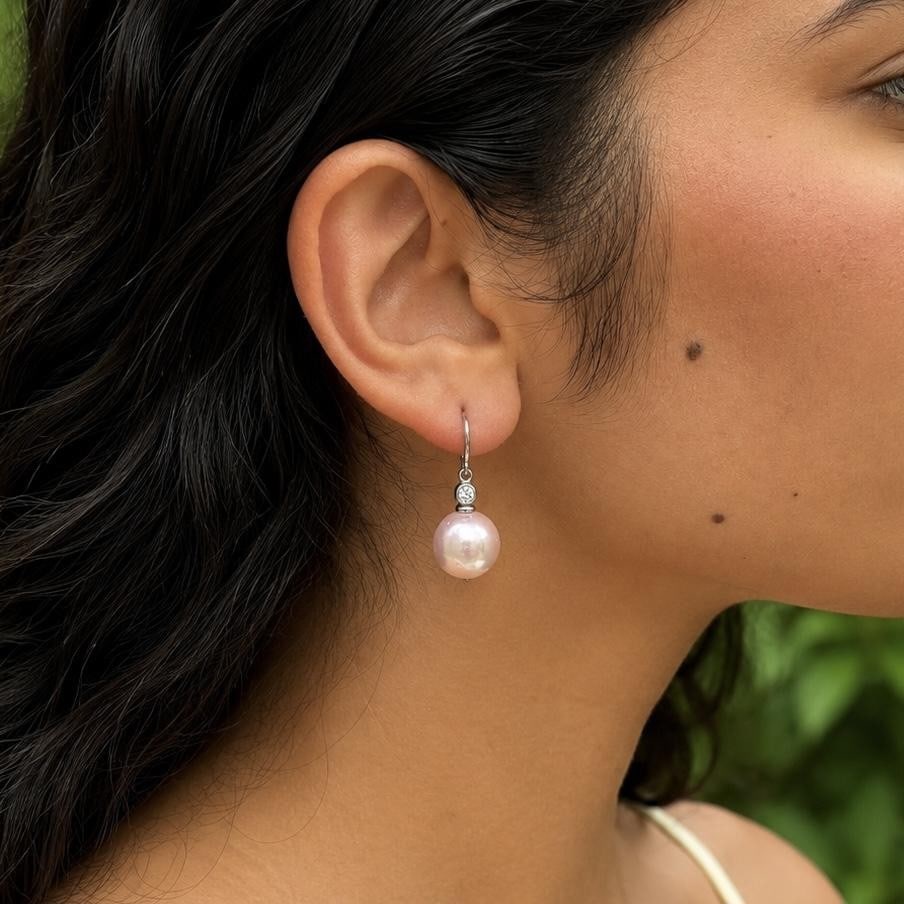 Sterling Silver Pearl Dangle Earrings with White Cubic Zirconia: Sterling Silver Pearl Dangle Earrings with White Cubic Zirconia Elegant dangle/drop earrings featuring round pink cultured pearls accented with white cubic zirconia in sterling silver. Designed with l