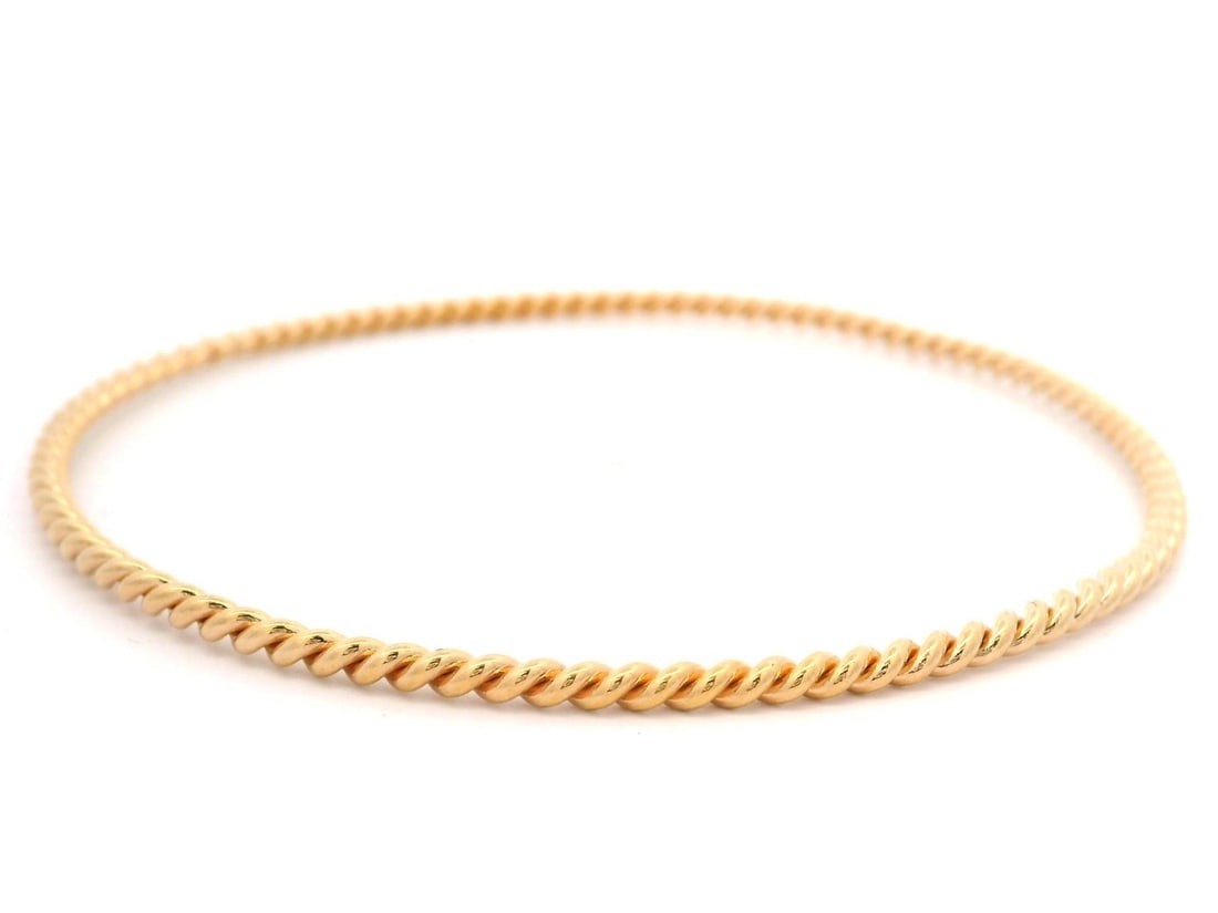 18k Rose Gold Slip On Twisted Cable Bangle: 18k Rose Gold Slip On Twisted Cable Bangle Classic slip-on bangle bracelet crafted in solid 18k rose gold with a twisted cable design. This stackable bracelet is pre-owned and shows light wear, with e