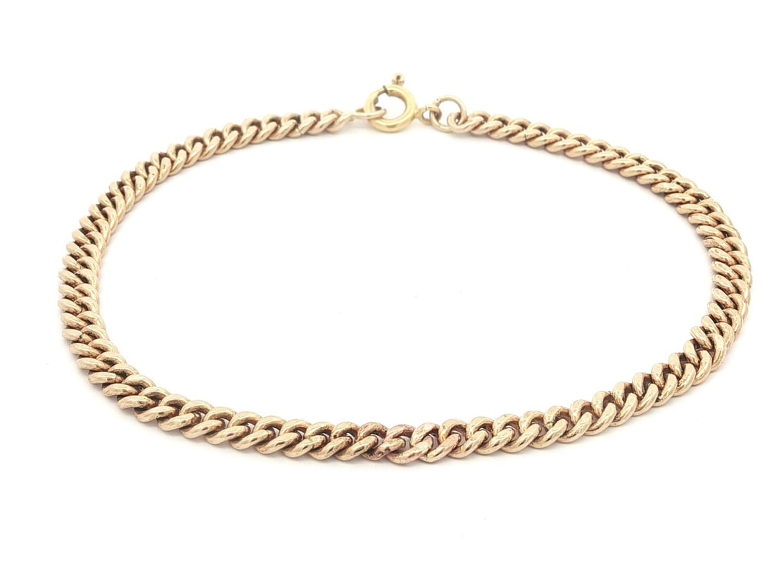 12-14k Yellow Gold 7in Curb Link Bracelet Unisex: 12-14k Yellow Gold 7in Curb Link Bracelet Unisex Vintage unisex curb Cuban link chain bracelet in yellow gold with a classic profile and solid construction. The bracelet features a spring ring clasp a