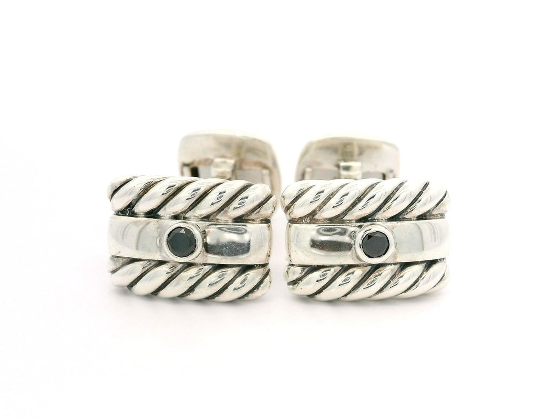 David Yurman Men's Sterling Silver Black Diamond Cufflinks: David Yurman Men's Sterling Silver Black Diamond Cufflinks Elevate your style with these exquisite David Yurman Men's Sterling Silver Round Bezel Set Black Diamond Cable Cufflinks. Crafted from solid 