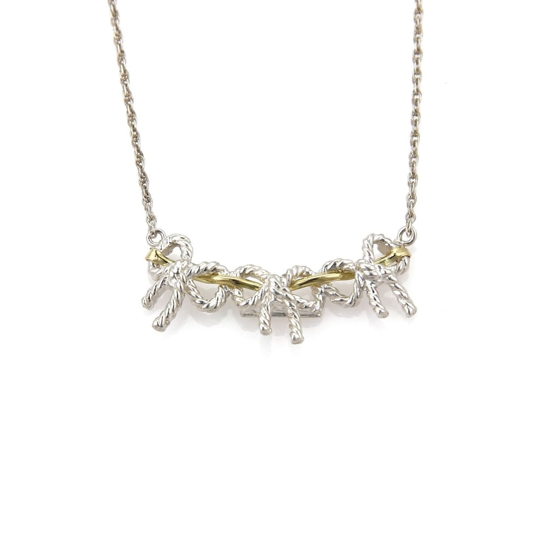 Tiffany & Co. Three Wire Ribbon Bow Necklace 18k Gold Sterling Silver: Tiffany & Co. Three Wire Ribbon Bow Necklace 18k Gold Sterling Silver Tiffany & Co. Three Wire Ribbon Bow necklace featuring a sculpted bow pendant in 18k yellow gold and sterling silver. This pendant
