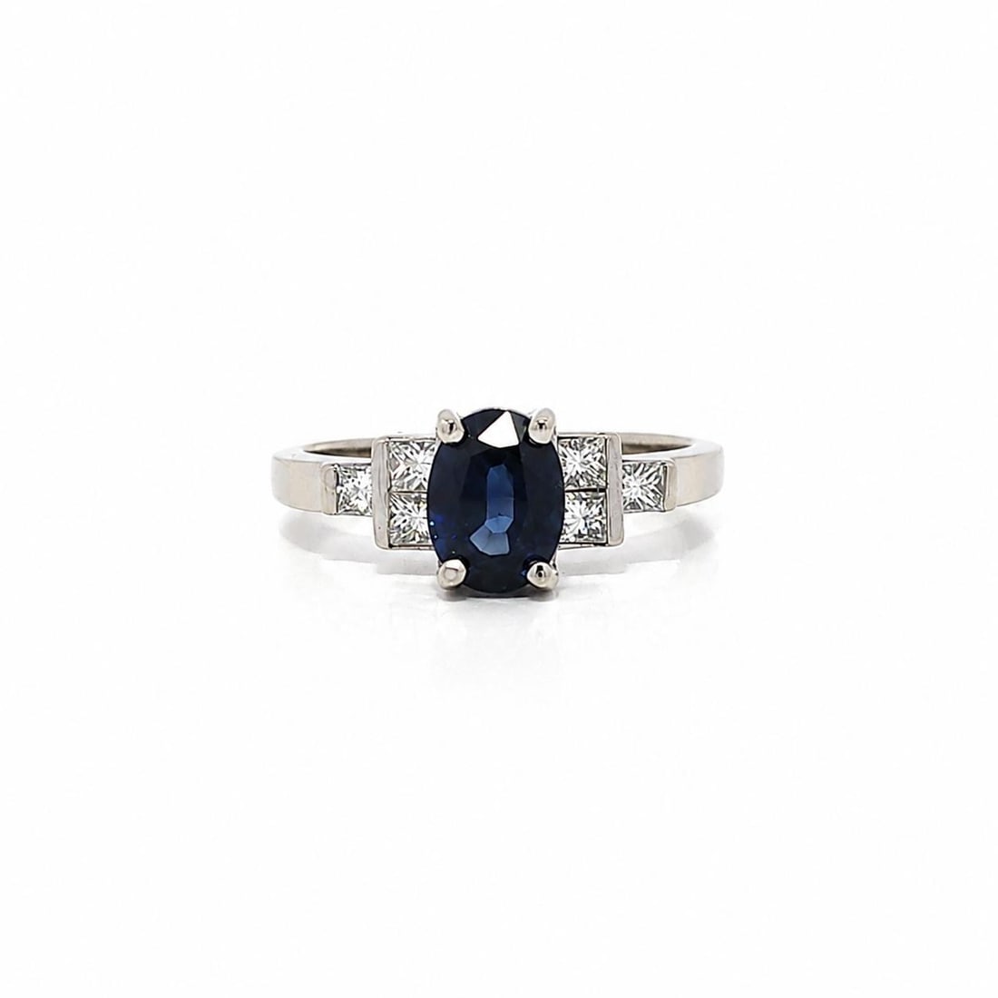 GIA Sapphire and Princess Diamond Cocktail Ring in 14k White Gold: GIA Sapphire and Princess Diamond Cocktail Ring in 14k White Gold Vintage cocktail ring crafted in solid 14k white gold, featuring an oval natural blue sapphire accented by six princess-cut diamonds i