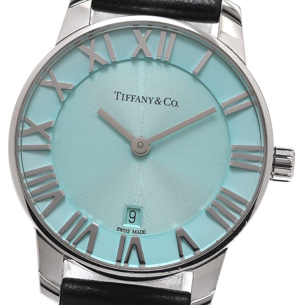 Tiffany Co Atlas Womens Quartz Date Watch Ref 63452785: Tiffany Co Atlas Womens Quartz Date Watch Ref 63452785 Tiffany & Co. Atlas Date ladies wristwatch with quartz movement and a blue dial. This Swiss-made watch features a stainless steel case, leather s