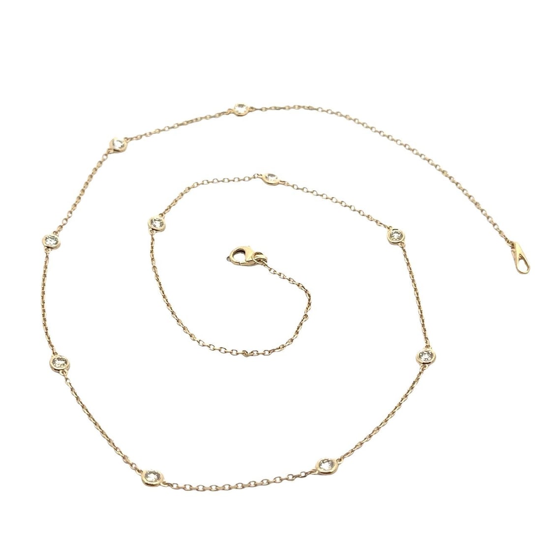 14k Yellow Gold 0.81ct Round Diamond By The Yard Necklace: 14k Yellow Gold 0.81ct Round Diamond By The Yard Necklace This elegant necklace features a stunning chain design crafted from solid 14k yellow gold. It showcases ten natural round brilliant cut diamon