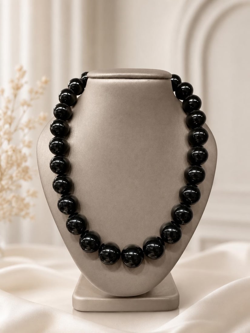 17 Inch Black Bead Strand Necklace with Yellow Gold Plated Clasp: 17 Inch Black Bead Strand Necklace with Yellow Gold Plated Clasp Large polished black bead strand necklace featuring approximately 27 round beads and a yellow gold plated push clasp. This pre-owned pi