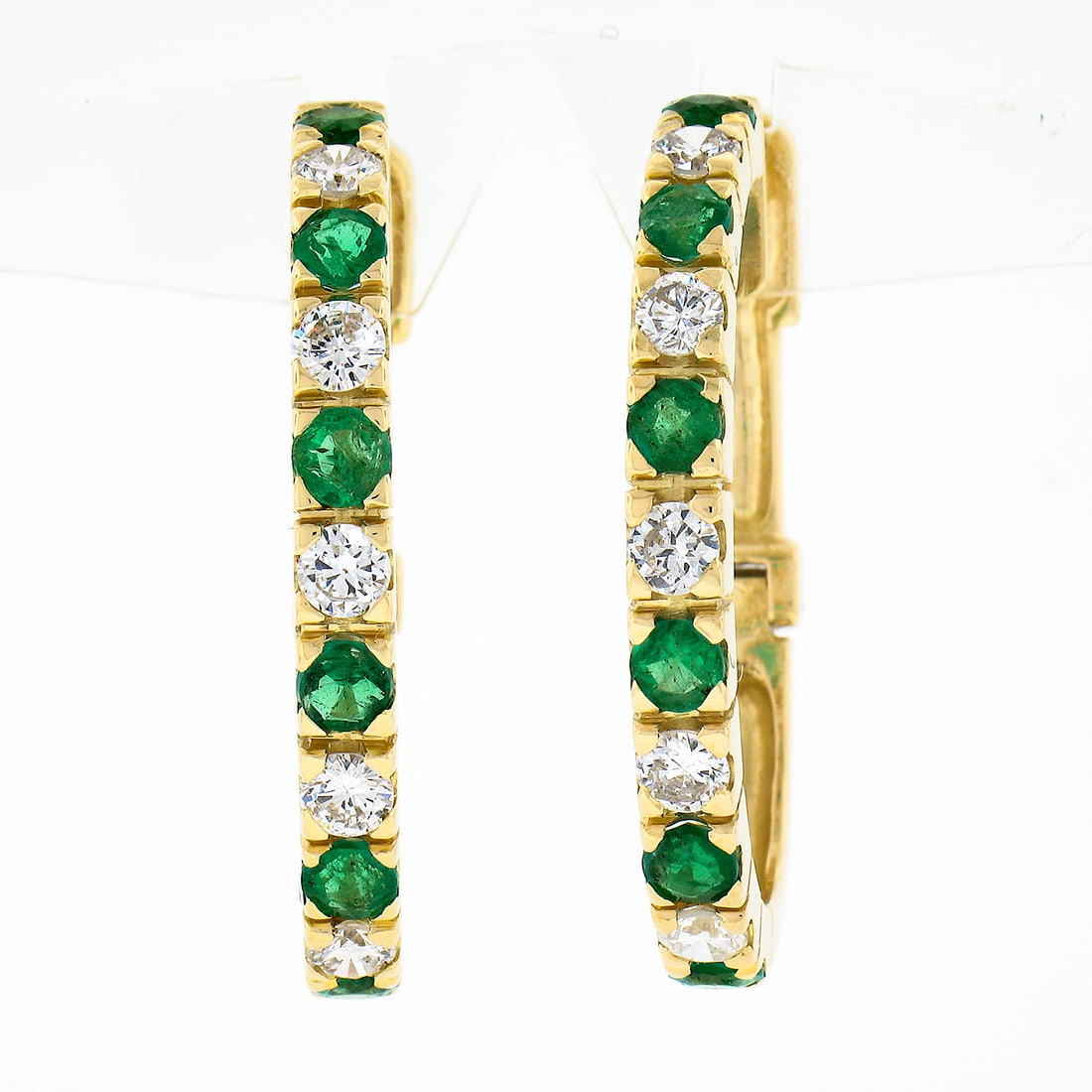 18K Yellow Gold Oval Hoop Huggie Earrings with Emerald and Diamond 2.74ctw: 18K Yellow Gold Oval Hoop Huggie Earrings with Emerald and Diamond 2.74ctw Pair of oval hoop huggie earrings crafted in solid 18k yellow gold, set with alternating natural emeralds and natural diamond