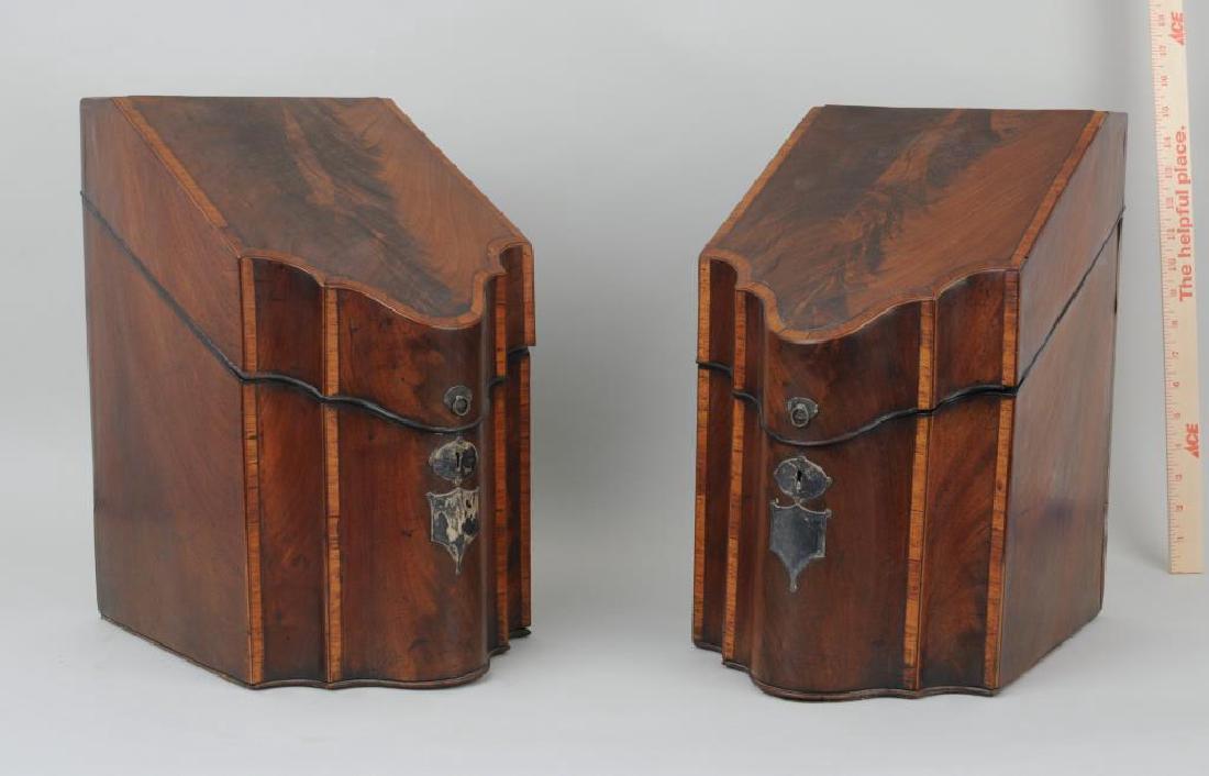 Pair George III Inlaid Mahogany Knife Boxes: Pair of George III inlaid mahogany knife boxes with ring handles and shield shaped key plates. Veneer cracks, age cracks, small losses, wear, losses to lock area. 15" high, 9" wide. Provenance: From a