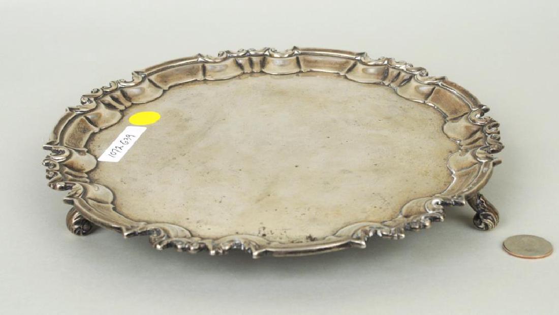 English Sterling Silver Salver: English sterling silver salver made in London in 1897, maker's mark for William Hutton and Sons. Light scratches. 1 1/4" high, 10 1/4" wide. Weight: 22 OZT. Provenance: Property of a CT Gentleman.